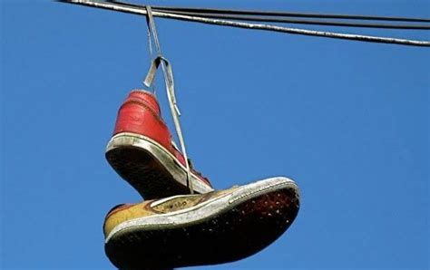 the meaning behind shoes strung up on a power line